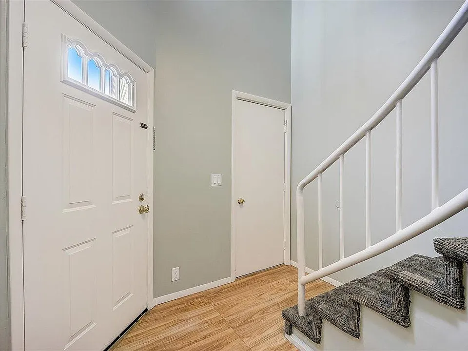 Main entry with front door (left), garage entrance (center), stairs (right).
