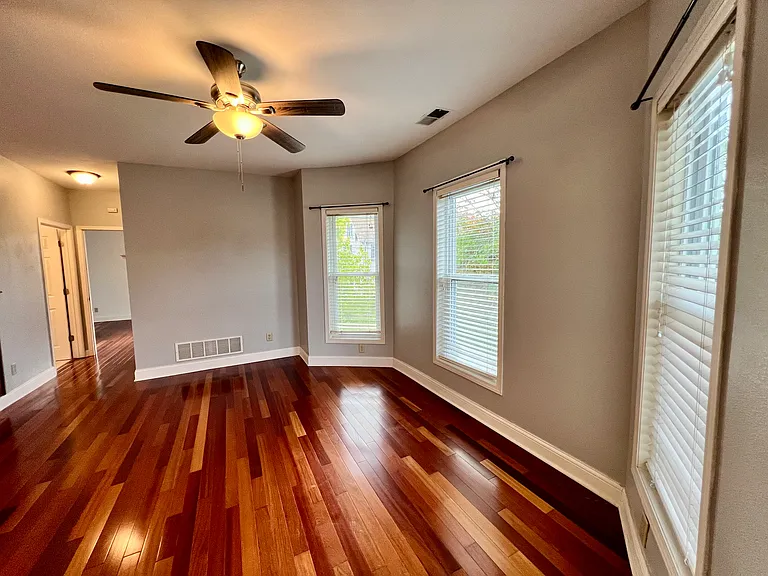 Large Living room, note the new window blinds and how much light the unit gets. Hardwood floors are great for pets. Bedrooms in this unit are separated by the living space, which provides privacy and tranquility.
