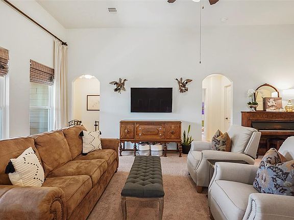 Buy the biggest TV you can afford; there's plenty of wall space. The hall to the left of the TV leads to the primary bedroom. Looking from the kitchen to the living room.
