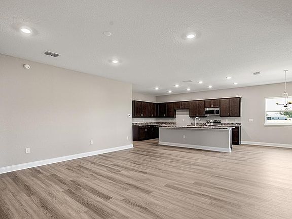 This home features a light-filled, open-concept main living area - Monroe by Highland Homes
