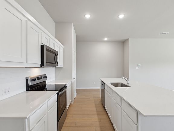 Kitchen in the Diamond home plan by Trophy Signature Homes - REPRESENTATIVE PHOTO