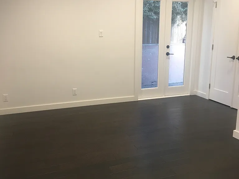Primary bedroom with french doors onto enclosed patio