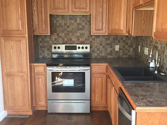 Brand new kitchen with glass top stove, dishwasher and refrigerator