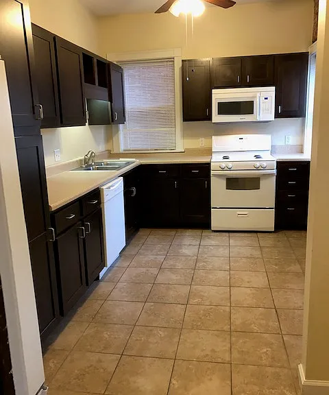 Spacious kitchen with lots of cabinets, counter space, gas stove, microwave, dishwasher, disposal, and refrigerator