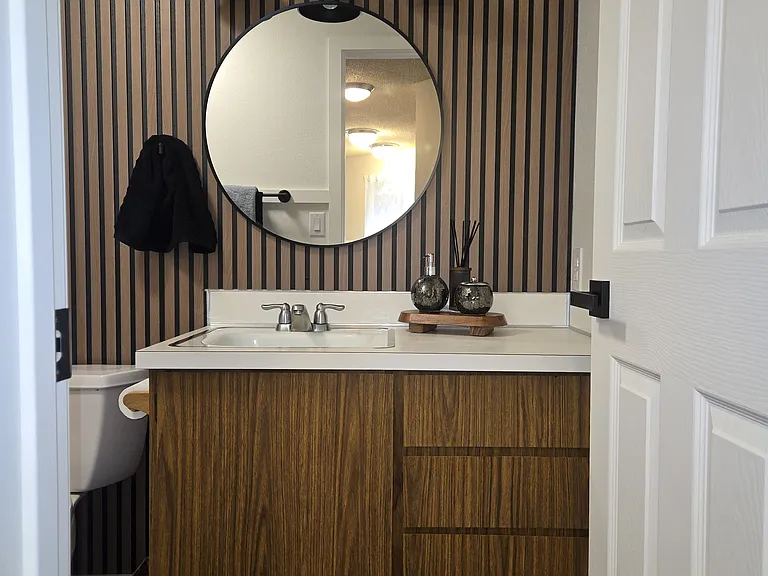 Handsome cosmetic upgrades to bathroom. (rugs and staging items not included).