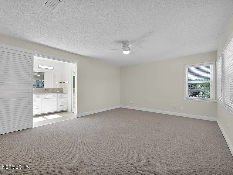 Master bedroom with views over back yard and golf course