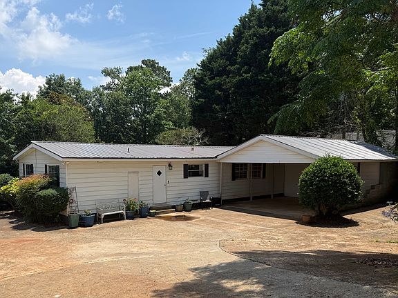 Rear view of home , large parking area, covered parking