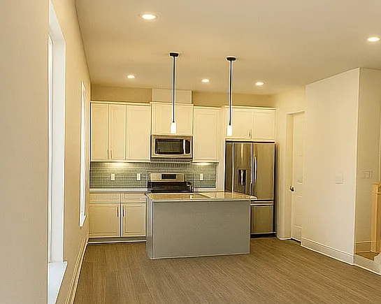 This stunning kitchen offers the perfect blend of style and functionality _ featuring sleek modern finishes, ample counter space, and abundant cabinetry for all your storage needs. The spacious island provides the ideal centerpiece for entertaining.
