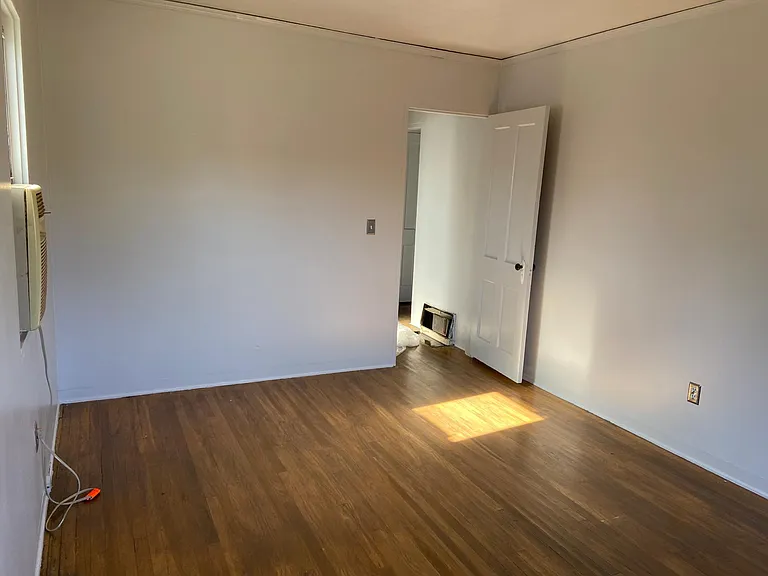 Front bedroom looking into hallway, you can see the AC unit.
