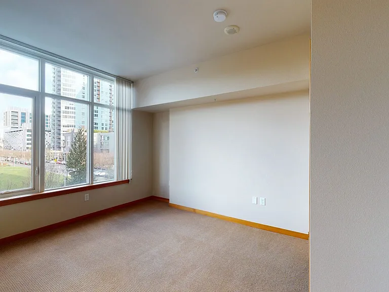 Spacious apartment bedroom with plush carpet flooring