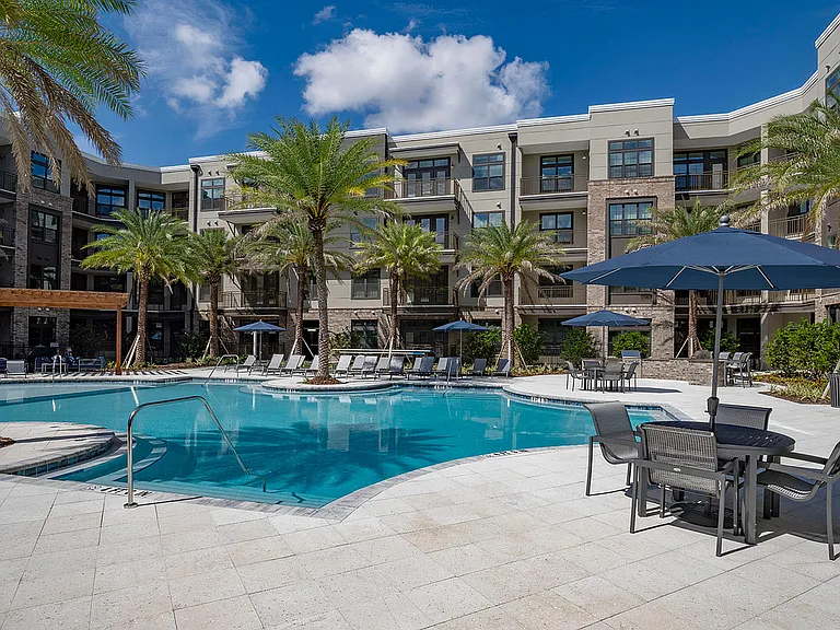 Experience serene luxury with this beautifully landscaped poolside at our modern apartment complex.