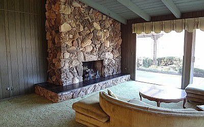 Floor to Ceiling Rock Faced Fireplace