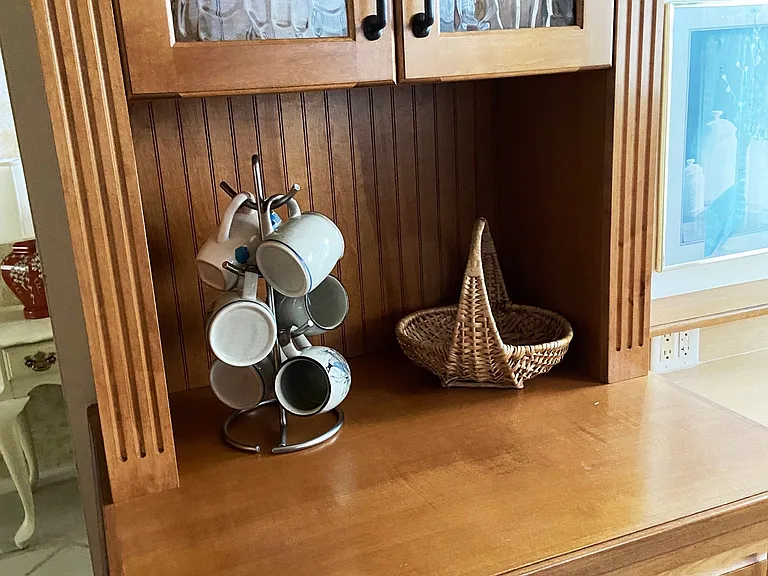 custom built-in hutch with glass shelves, glass door inserts, and display lighting.