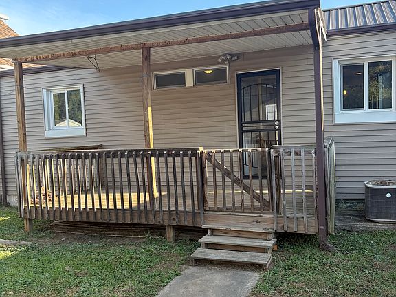 Back porch with security door. Security fence around back yard.