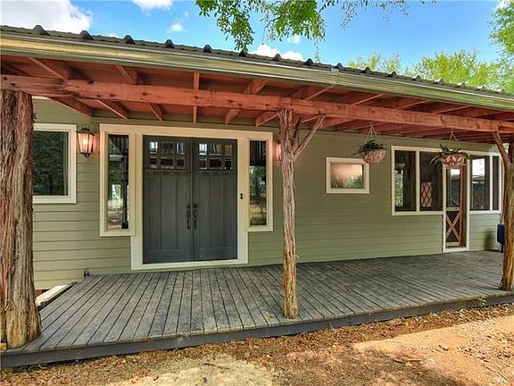 Solid craftsman front doors, large front porch open to nature, screen door to the right offers access to the screen porch and yert