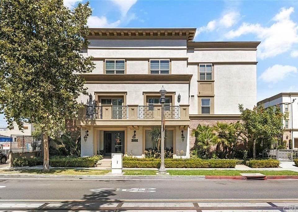 Street view of the building and the unit's balcony.