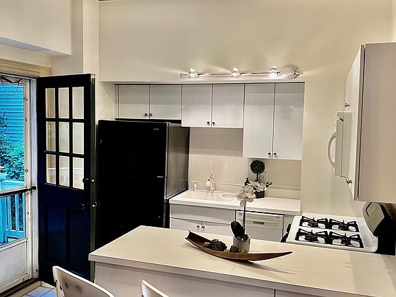 Kitchen with gas stove and leads out to large deck