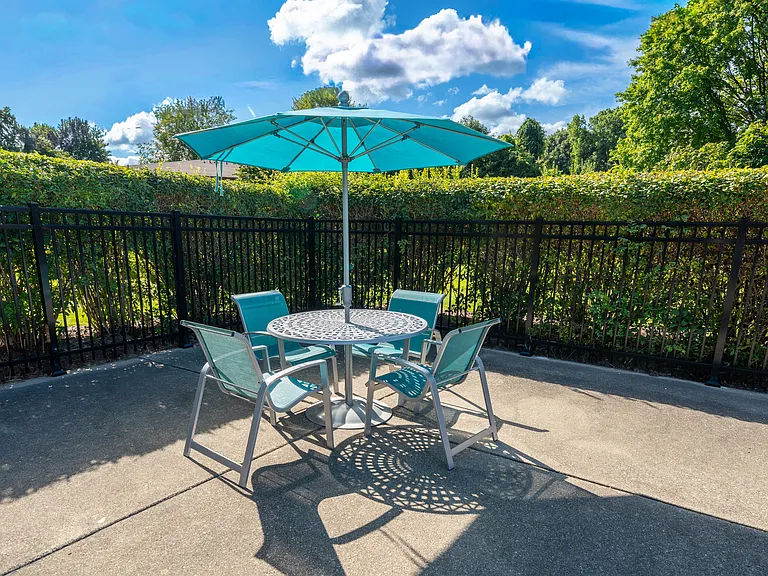 Umbrella and Chairs on Sundeck at Westwood Village Apartments in Westland