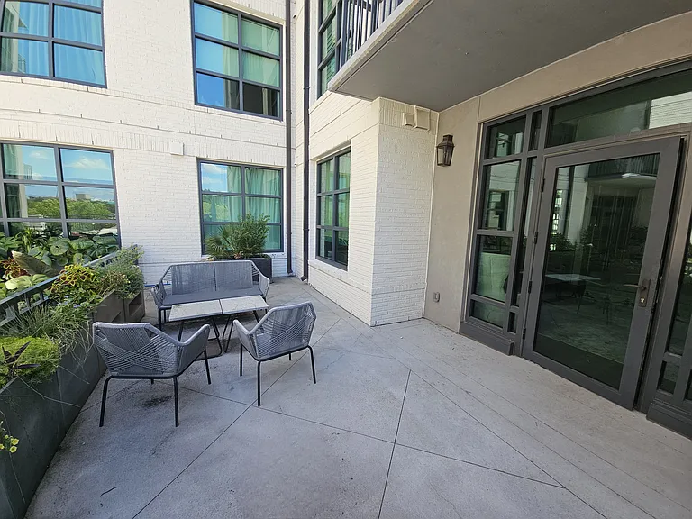 Private relaxing patio arranged with seating and plants