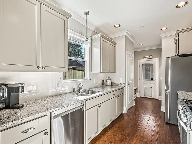 Kitchen, view to rear entry area and door to lanai and 2 car garage.