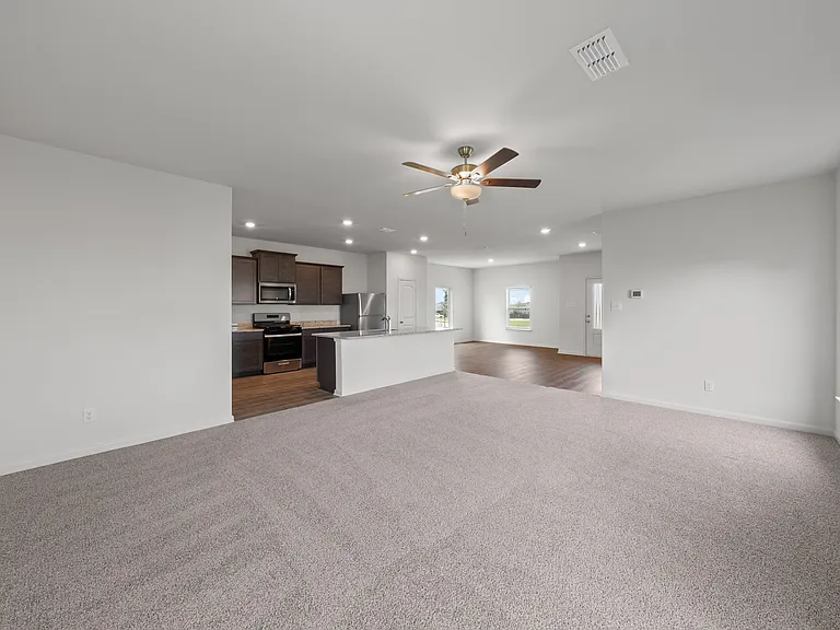 The open-concept layout of this floor plan has the kitchen, family room and dining room sitting next to one another.