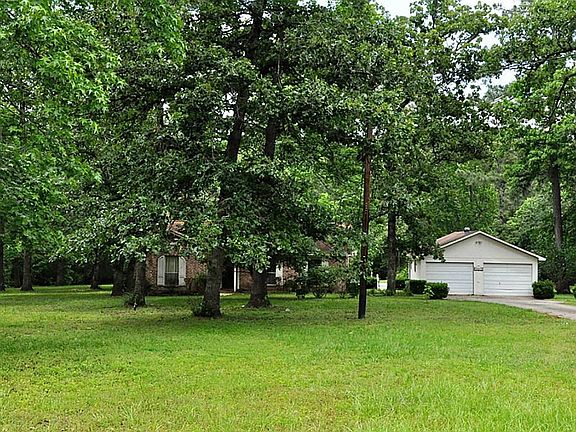 View of the home from the street.  Tree and bushes give privacy of the front door.