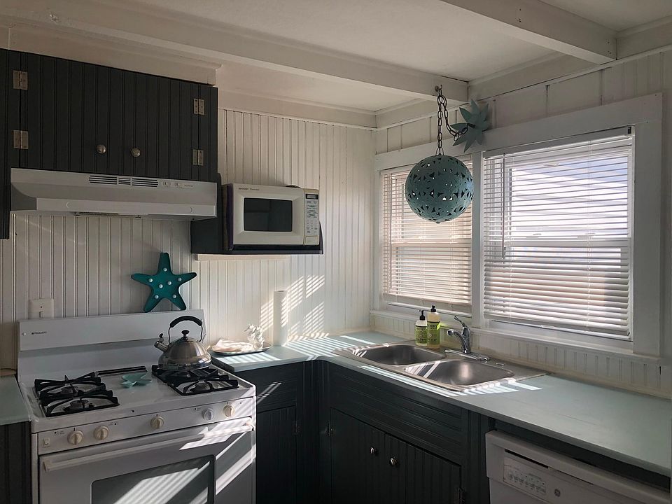 partial kitchen view, small white microwave is replaced with an OTR full size microwave.