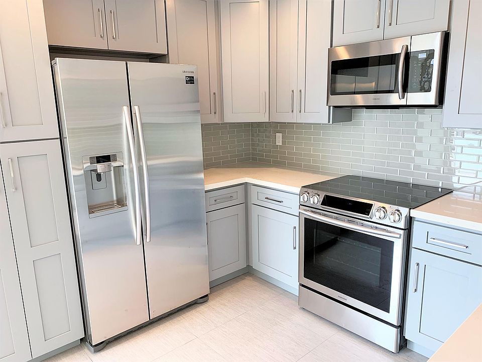 Kitchen with brand new Samsung appliances. Features a huge refrigerator with in-door water and ice, chef's range with large oven and a microwave hood