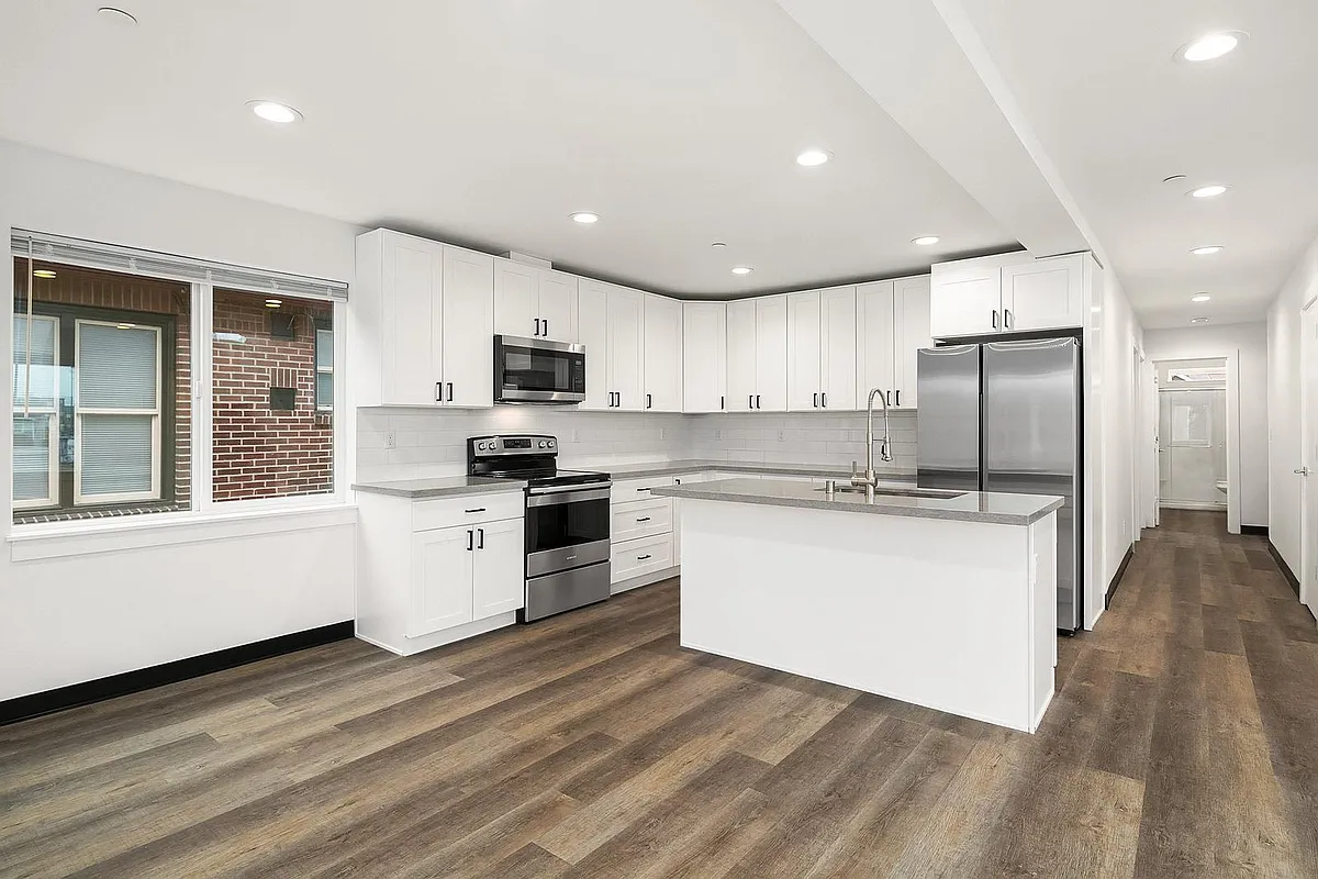 Kitchen (pictured unfurnished) comes furnished with barstools, pots, pans, cups, glasses, plated, utensils, small appliances, etc. - 5004 7th Ave NE #B