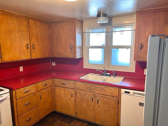 Kitchen with stove, refrigerator and dishwasher.