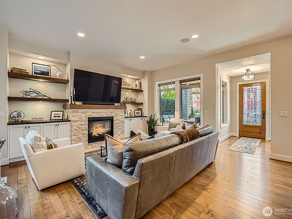 Living room with recently updated custom fireplace and gorgeous built-ins>