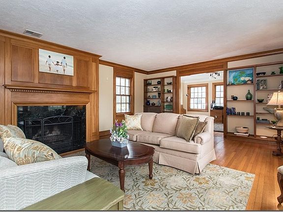 Spacious Living Room with woodburning fpl, built-in shelving and natural woods