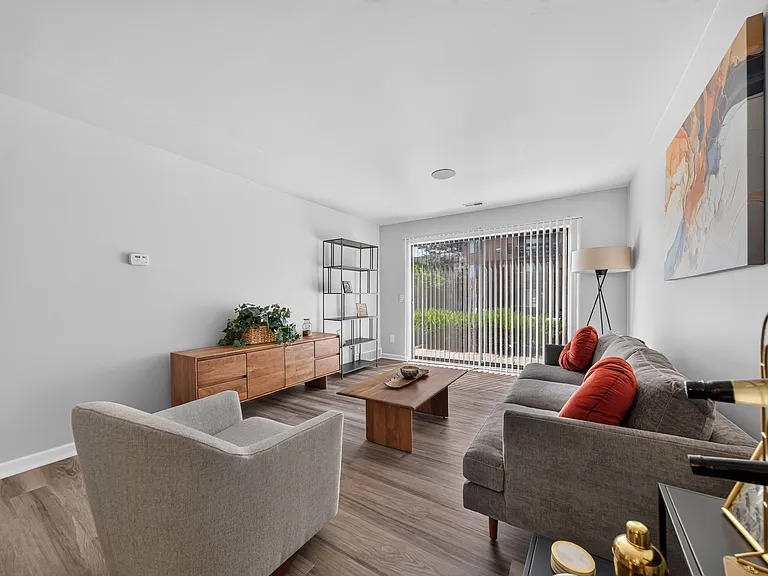 Spacious Living Room with Sliding Glass Door at Lakeside Village Apartments in Clinton Township, MI