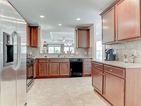 Huge kitchen with tile floors, ample cabinet and counter space