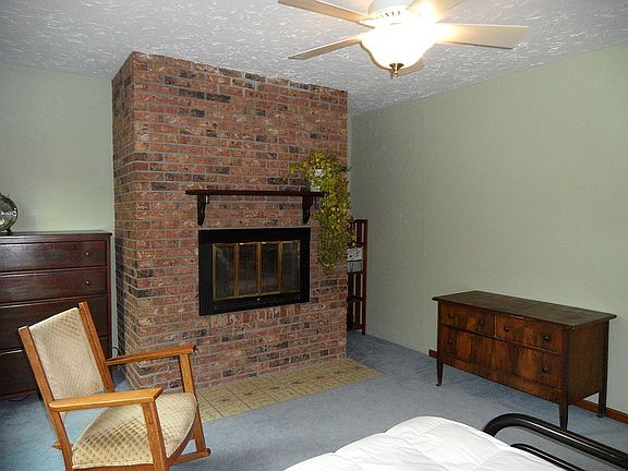 Bedroom with brick fireplace