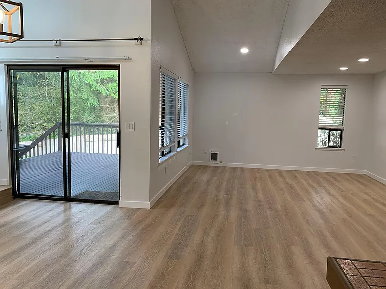Light filled living area with large windows facing the private backyard.