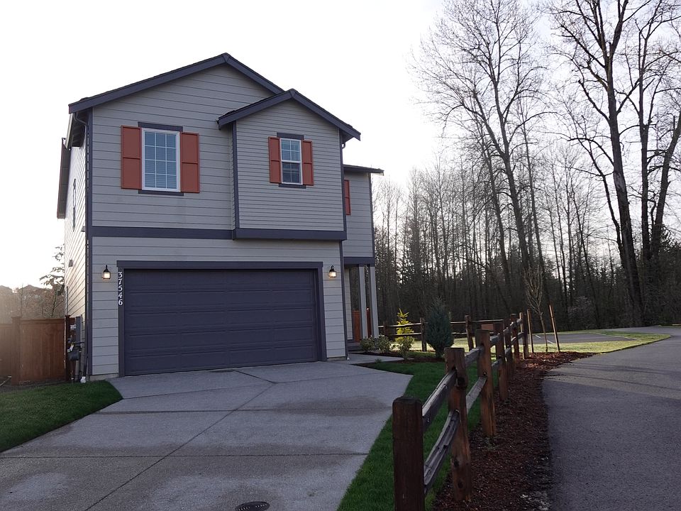 Front of the house. Expansive Driveway.