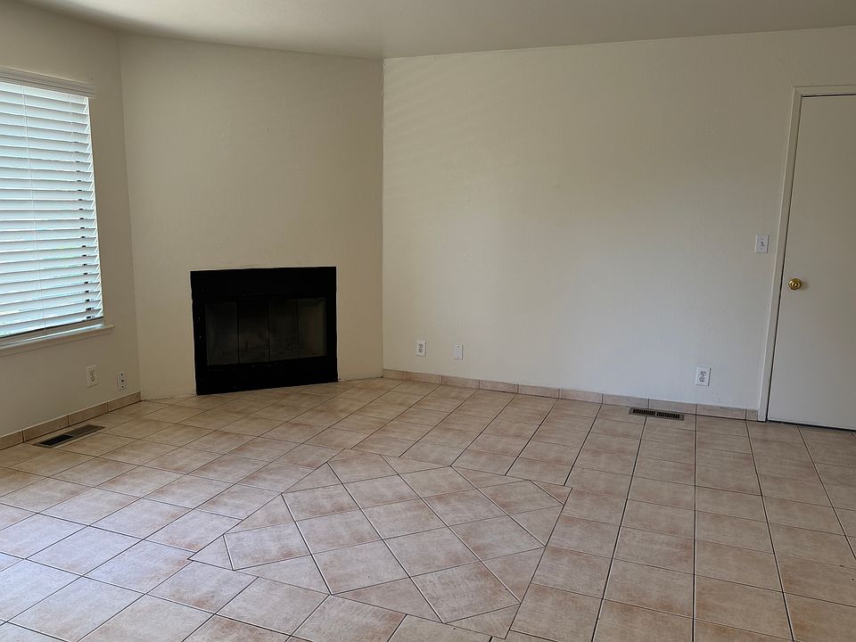 Tiled living room and Wood-burning Fireplace 
Downstairs