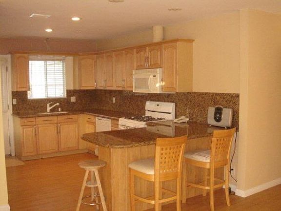Open Kitchen with granite counter top & dining island.