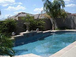 Stunning fenced pool with water feature