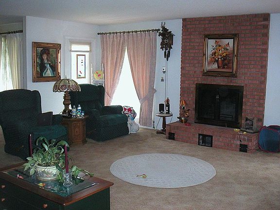 Looking from the hall into the living room and fireplace.