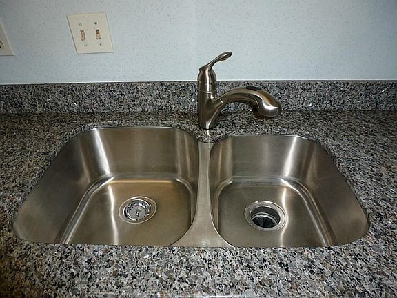 Take a look at this great deep stainless steel double under mount sink with new faucet surrounded by
