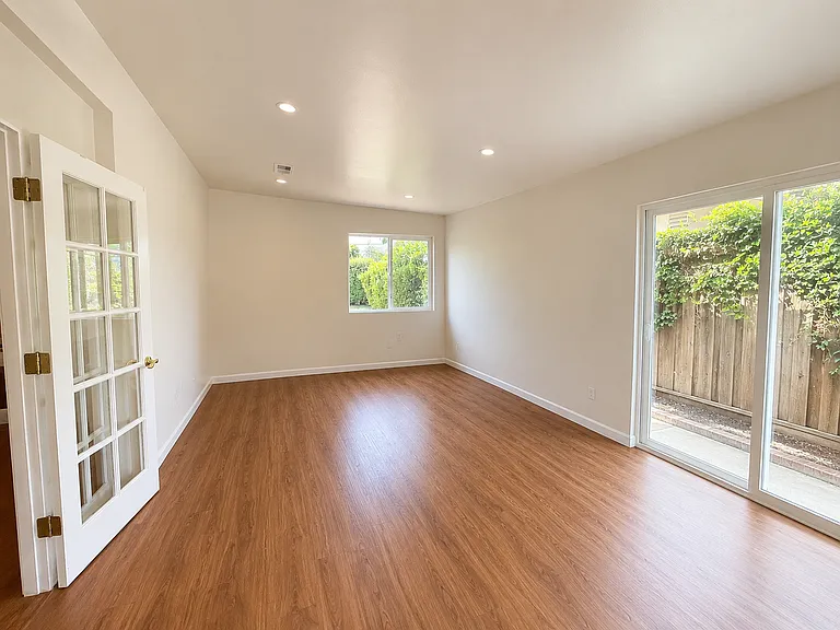 Bright, Minimalist family room interior with French door
