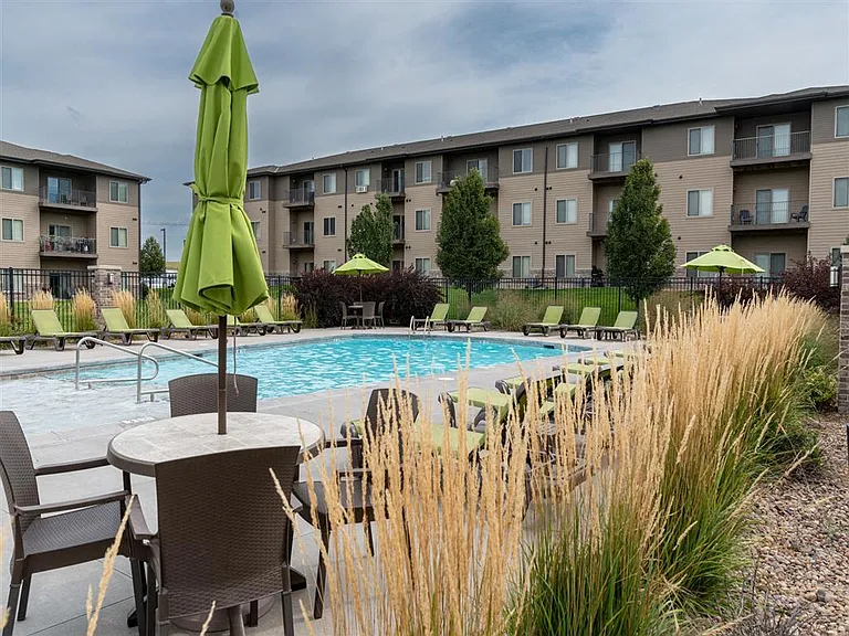 Tables and chairs next to pool at The Sterling at Kearney.