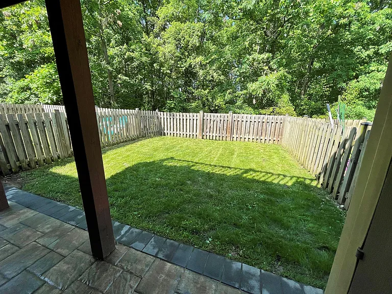 Fenced in yard backs to woods for added privacy