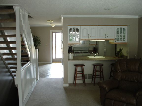 The main hallway leads to the upper staircase, the kitchen and the family room