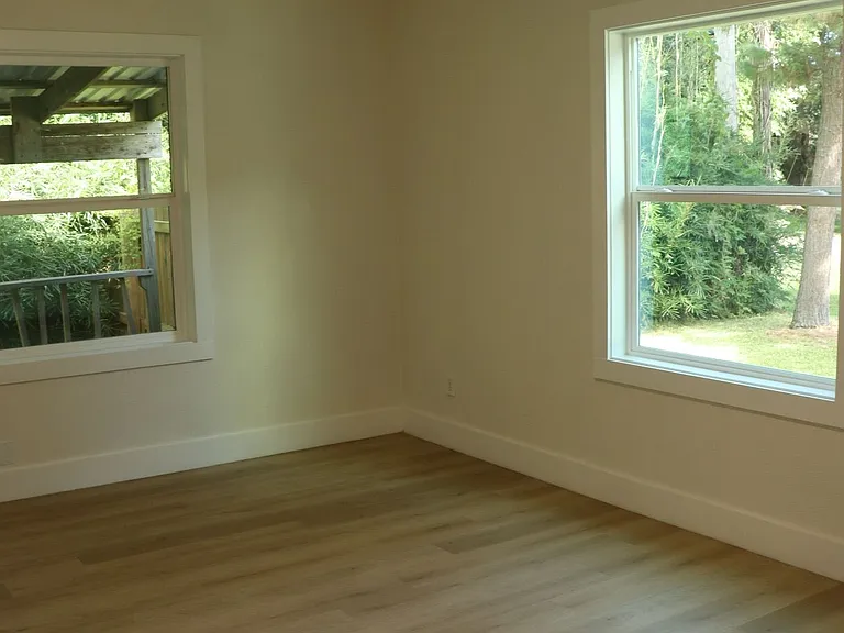 Comfortable secondary bedroom with bright window views.