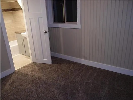 bedroom with door to bathroom