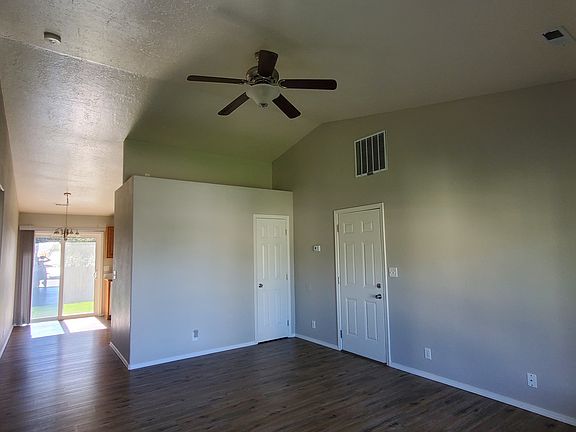 Living room. Small closet, garage door, and entrance to kitchen shown.