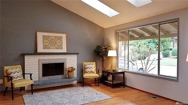 Living room with huge window and skylights for ample lightin